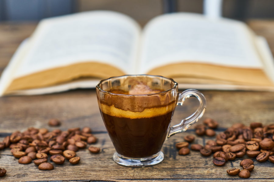 A shot of espresso with coffee beans