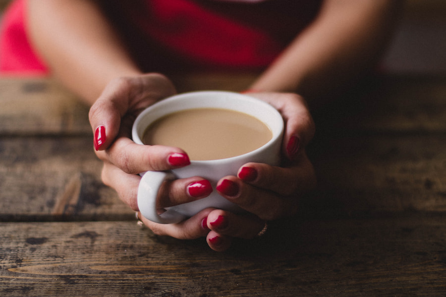 A woman holding a cup of coffee