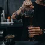Barista pouring brewed decaf coffee