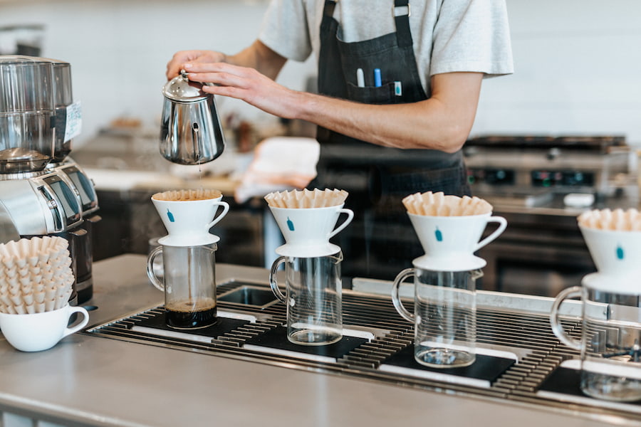 A barista using a kettle