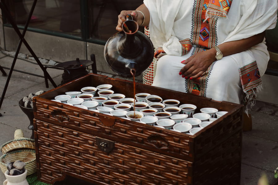 An image of a person pouring Ethiopian coffee