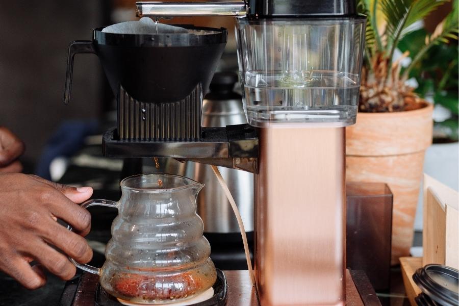 An image of a person using a coffee maker