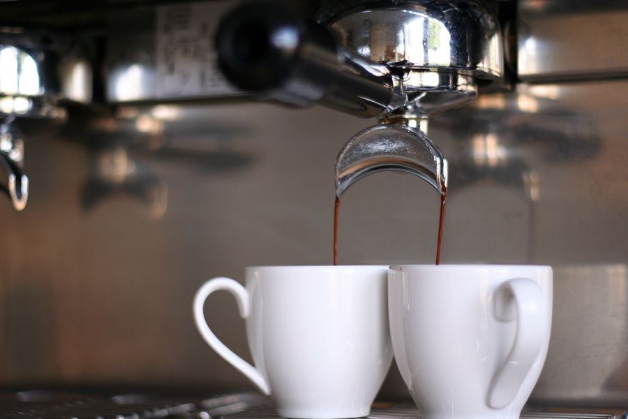 Espresso machine pouring coffee for 2 cups