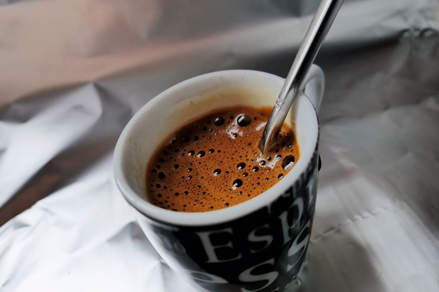 Spoon inside a cup of espresso