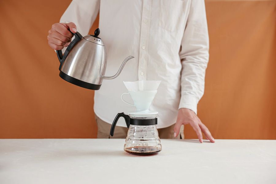 Person using the pour over coffee method