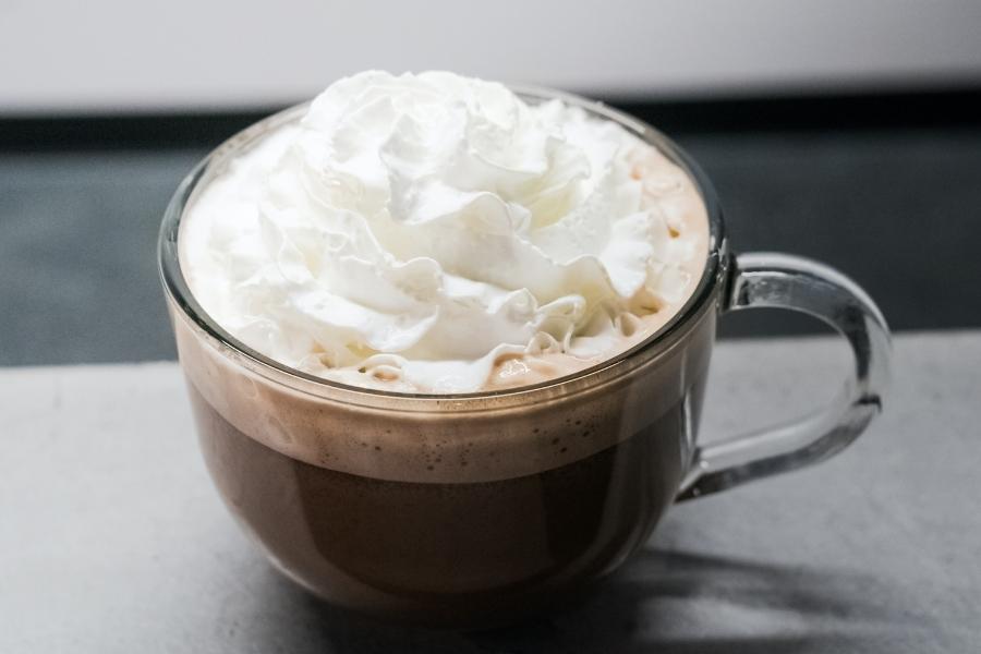 A heavy whipping cream in a big cup of coffee