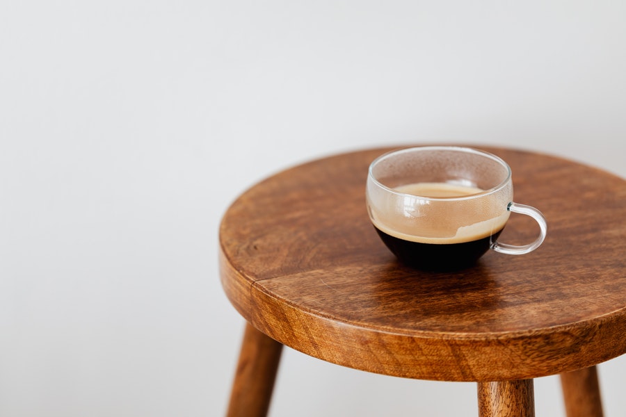 Coffee in a transparent mug placed on coffee table