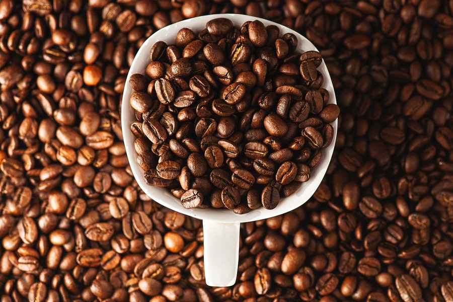 Coffee beans in a white cup