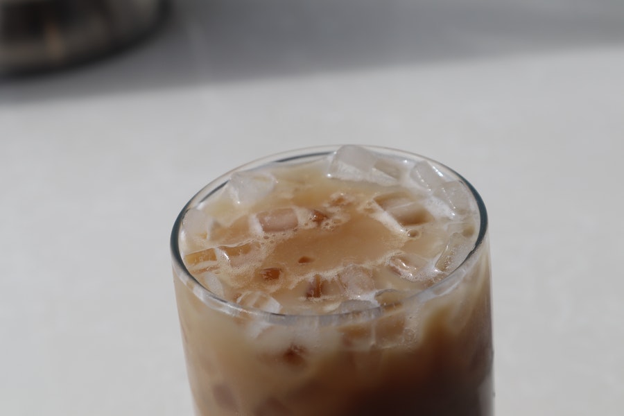 Latte filled with ice in a transparent glass