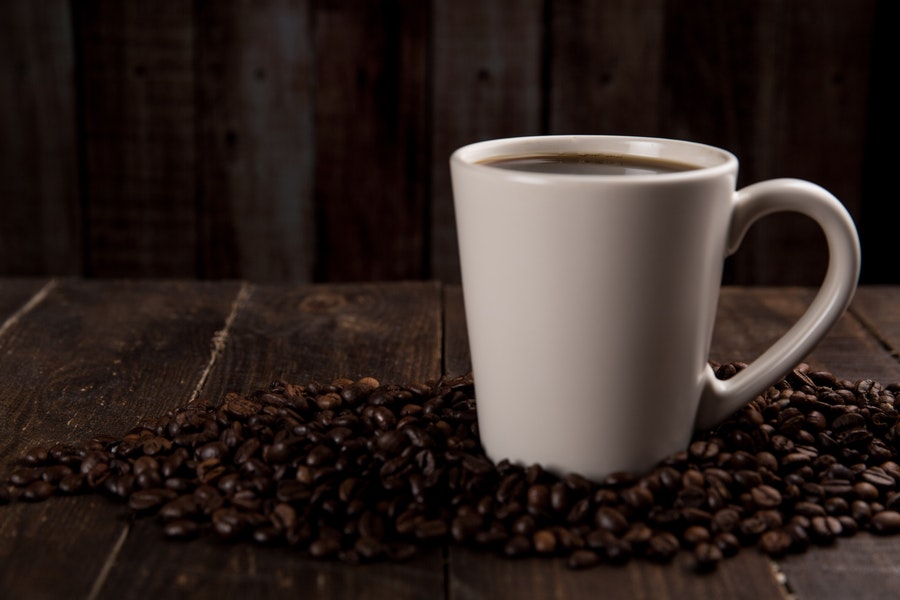 Brewed coffee and coffee beans on the table