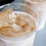 Iced latte in a transparent plastic container