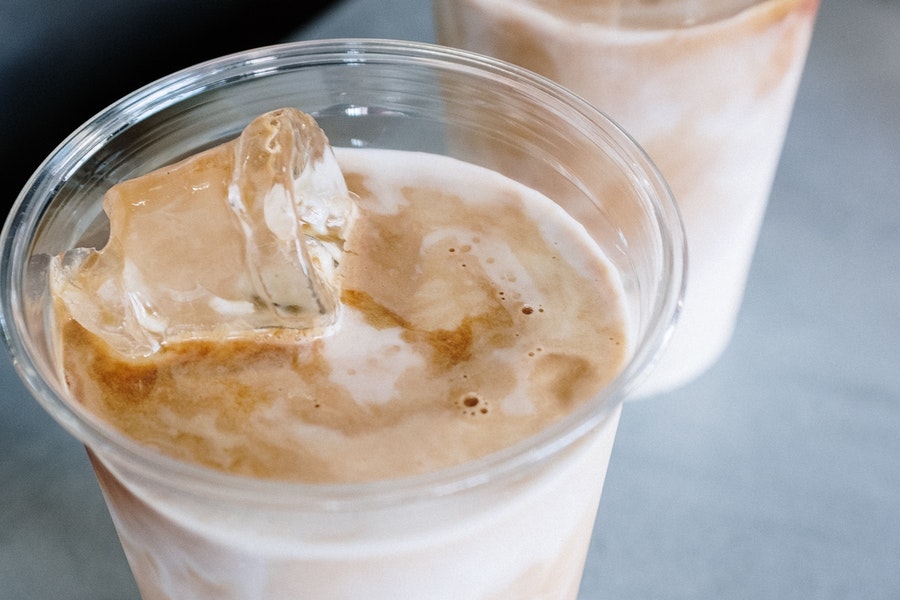Iced latte in a transparent plastic container