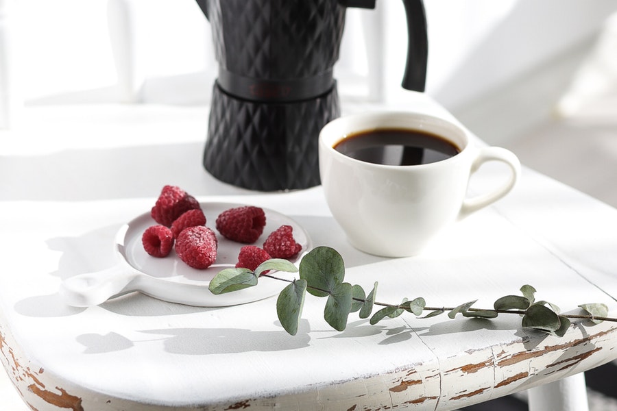 Black moka pot on a white table