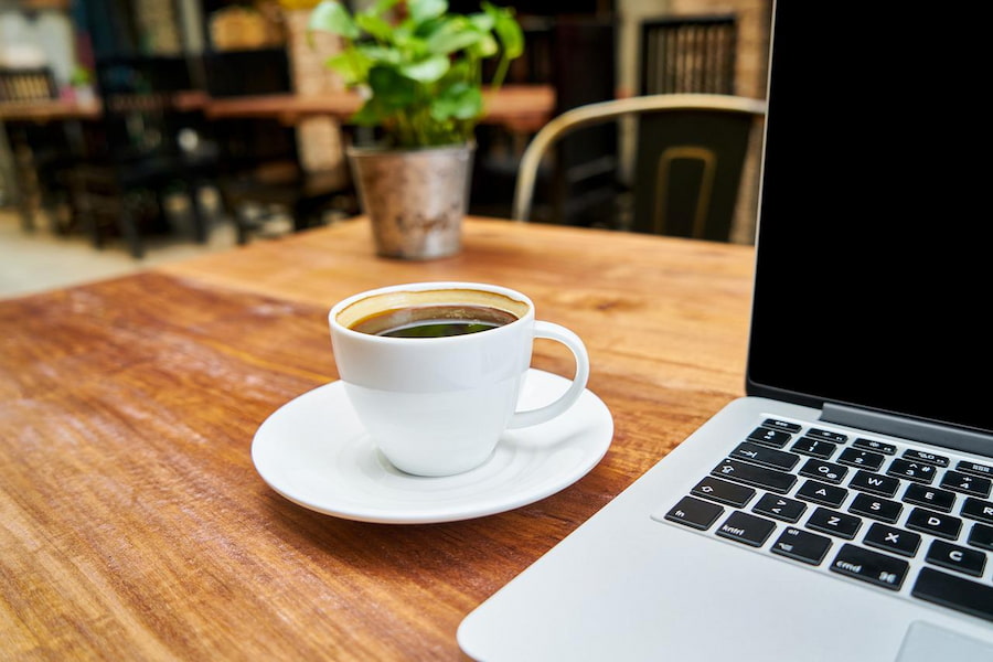 A cup of coffee and a laptop