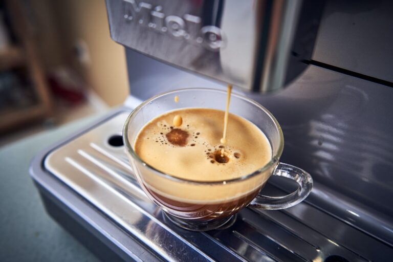 A silver Miele coffee machine making a hot cup of espresso