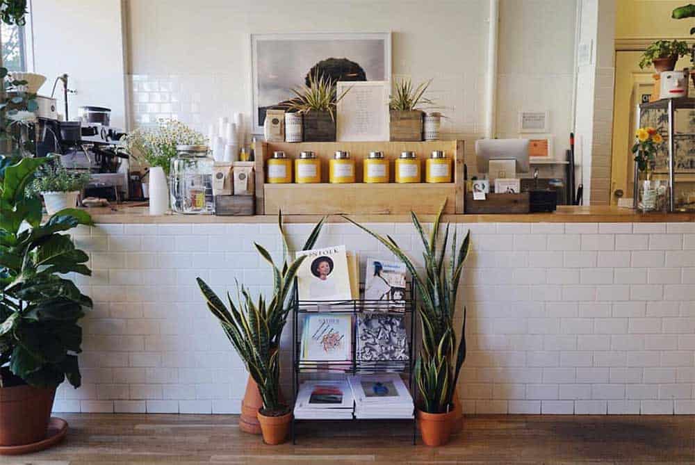 A coffee shop with machines and coffee products placed on pouches and yellow cans