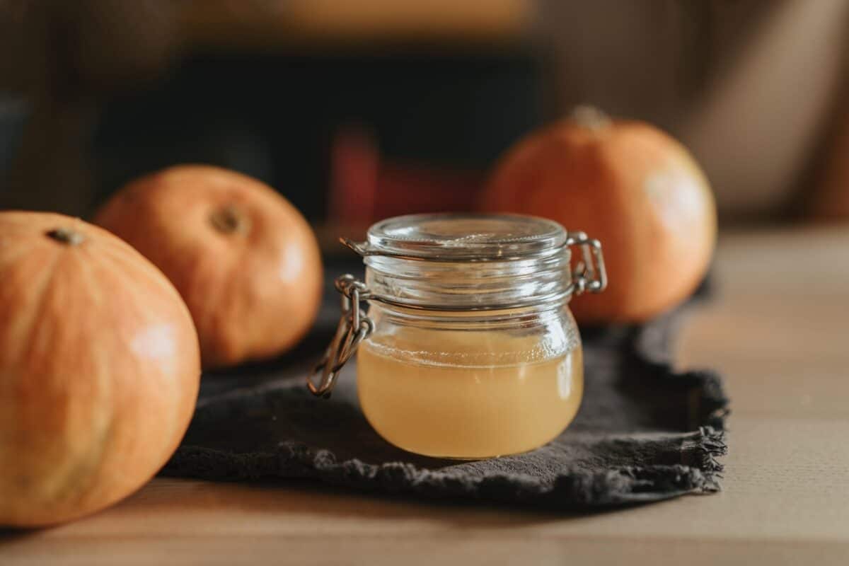 Apple cider vinegar in a small mason jar placed on a placemat