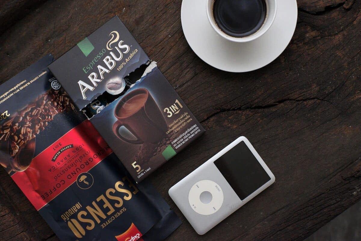 A box of 3 in 1 Arabus espresso beside a cup of coffee placed on a white saucer