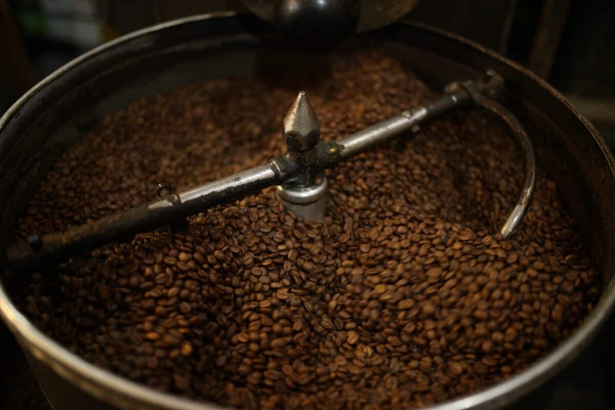 A close-up view of coffee beans being roasted on a coffee roaster