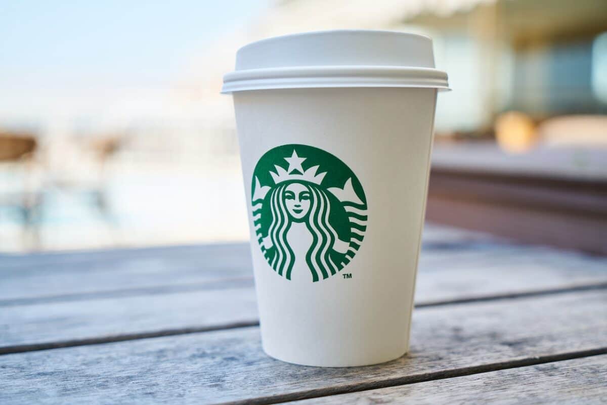 A close-up view of Starbucks disposable cup placed a wooden table